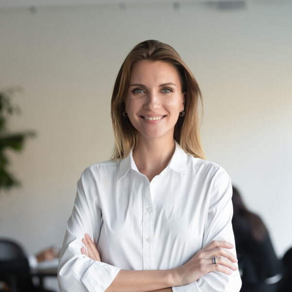 Smiling,Beautiful,Female,Professional,Manager,Standing,With,Arms,Crossed,Looking